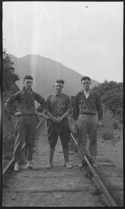 Three men on railroad tracks