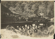 Mt. Tamalpais and Muir Woods Railway train and passengers cars crossing a trestle bridge