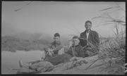 Three men sitting on beach at Willow Camp