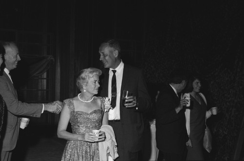 Roger Revelle (center), Scripps Institution of Oceanography scientist, professor, and administrator; with his wife Ellen Virginia (Clark) Revelle, at Roger's farewell retirement party. September 9, 1964