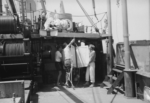 [Men with oceanographic instrument aboard R/V HORIZON]