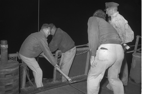 [Men with core barrel on deck of R/V Spencer F. Baird]