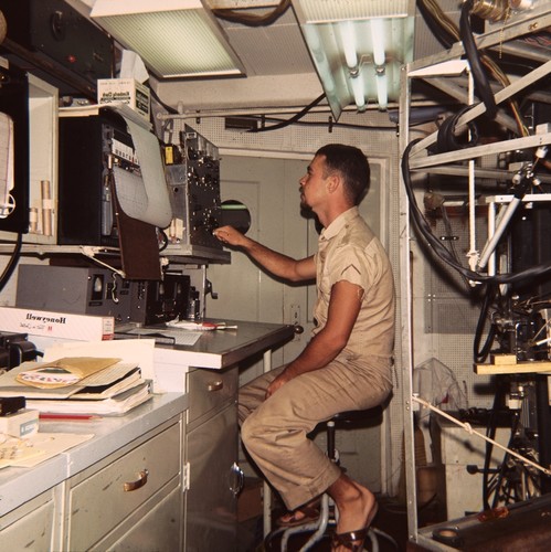 Unidentified scientist is shown here on watch on the research ship Argo during the Lusiad Expedition (1962-63). This expedition was an international effort to explore the Indian Ocean. On this expedition, the Scripps Institution of Oceanography research vessels Horizon and Argo sailed around the world to study the Indian Ocean, its currents and map its seafloor. Circa 1963