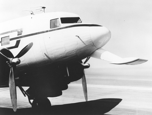 In 1962 Applied Oceanography Group (AOG) at Scripps Institution of Oceanography leased this DC-3 airplane and it would later be given to them for continued research. This photo shows the front nose view of the aircraft with the instrument extension showing. With the airplane it was possible to survey 10,000 square miles of sea surface in 24 hours. Circa 1965