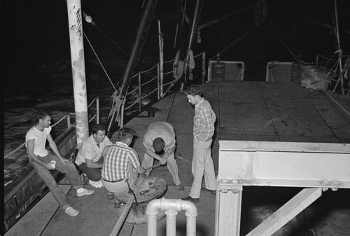 [Man with core barrel on deck of R/V Spencer F. Baird]