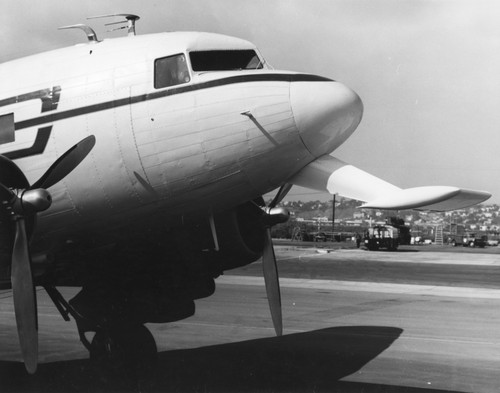 In 1962 Applied Oceanography Group (AOG) at Scripps Institution of Oceanography leased this DC-3 airplane. This photo shows the front nose view of the aircraft. Later the plane would be given to them for continued research; AOG then mounted an infrared radiometer to measure heat flow from the ocean in the plane. With the airplane it was possible to survey 10,000 square miles of sea surface in 24 hours. Circa 1965