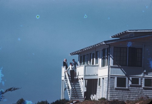 Carl L. Hubbs with his wife Laura Clark Hubbs (right), and Elizabeth M. Kampa (left) a graduate student in zoology, coming down the stairs at the "Community House" on the campus of Scripps Institution of Oceanography. February 1945