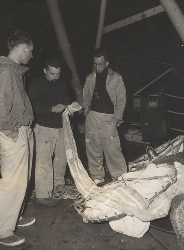 Jack Bradshaw, John McGowan, Motoda (?) examining plankton net. Transpac Expedition, 1953