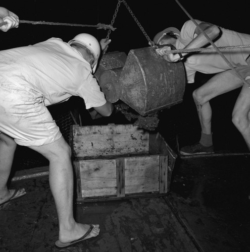 [Oceanographers examining contents of Peterson grab sampler]