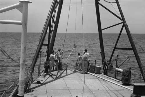 [Men working at A-Frame of R/V Spencer F. Baird]