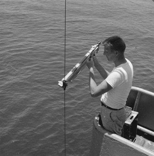 [Norman Anderson attaching Nansen bottle to wire]