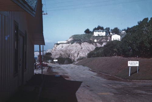 Service road on the Scripps Institution of Oceanography campus, with the "T" cottages in the background on the hills, where campus personnel lived can be seen on the hills in the background. February 1945