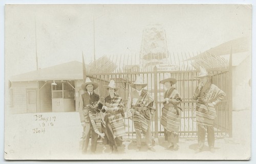 Tourists in Mexican costume at U.S.-Mexico border monument