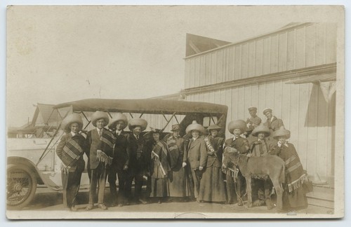 Tourists in Mexican costume, near tour bus, with donkey