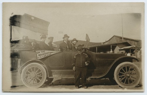 Automobile passengers with "On the boundary line" pennant