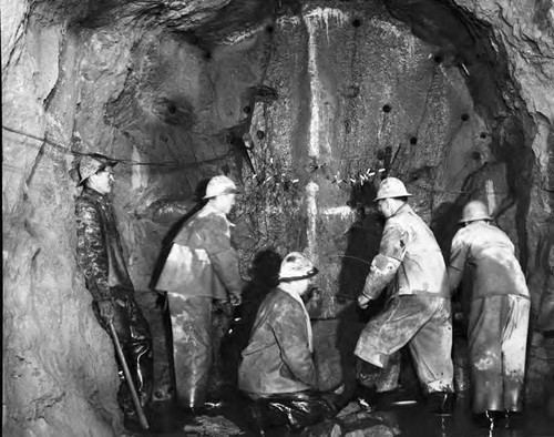 Miners at work drilling the tunnel