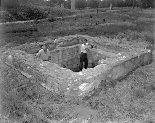 Fred Martin left and Gordon Lease measure old catch basin