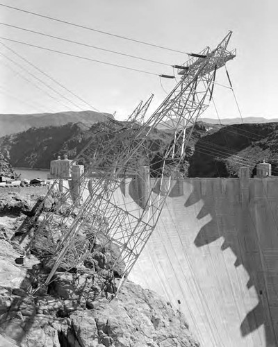 Three towers on edge of canyon walls bringing wires from power plant to switch rack carrying power for BTL