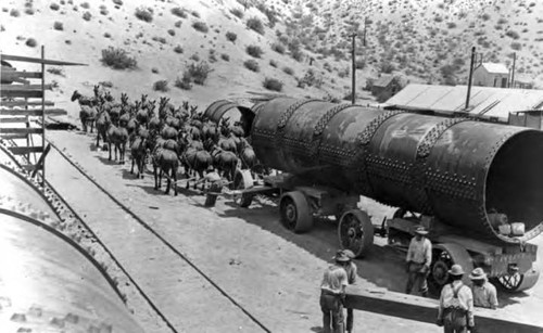 20-mule team hauling large section of penstock