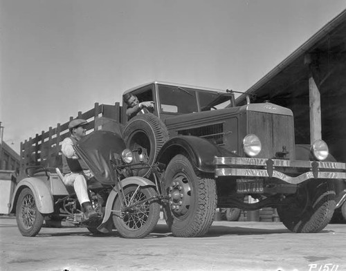 The biggest and smallest automotive equipment in use in the Department of Water and Power - Camile Brannier on the motorcycle and Tommy Hyans in the truck