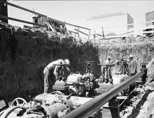 Workmen making final adjustments on new 12" service at MGM studios