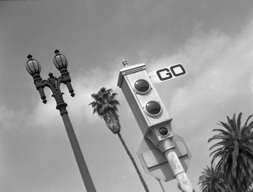 Electrically operated Los Angeles traffic signal, with City street light in background