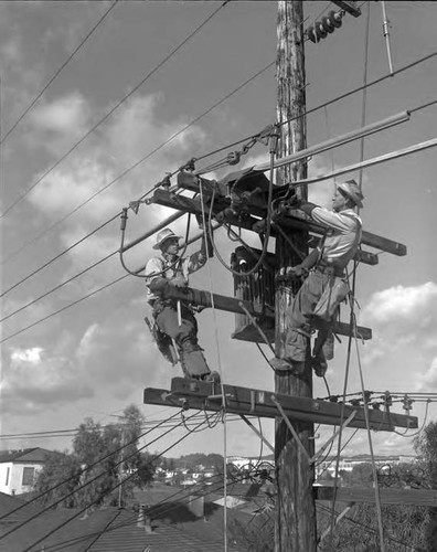 Linemen at work installing new overhead lines