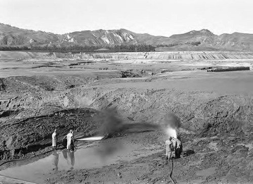 Hose crews sluicing out silt that had accumulated over a period of years – San Fernando Reservoir