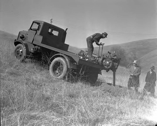 Earth borer being tested on hillside, the heavey duty truck will be used by operating division for power line construction