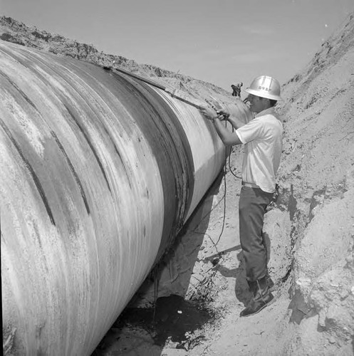 Checking welded seams on the Siphon on the second Los Angeles Aqueduct line between Mojave and little Lake, California