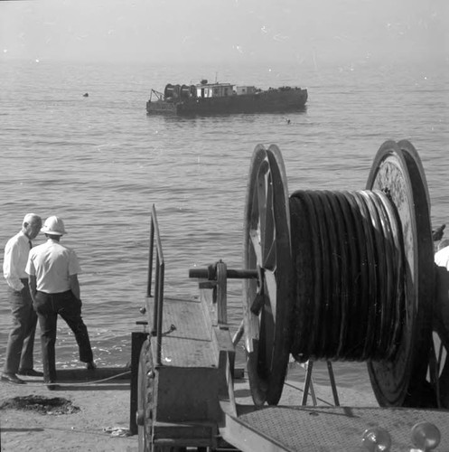 Cable being laid on 'ocean' floor by cable pulling barge at Sunset and Pacific Coast Highway