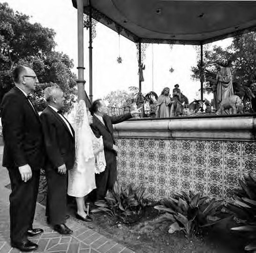 View of nativity scene from ground with Willis Fisher, Mario Valadez, Senara de Bonzo, and Harry Seidel looking on