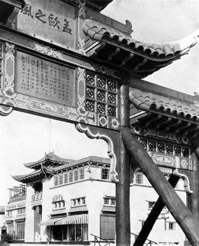 Photograph of a Chinatown plaza on Broadway. Forbidden Palace is the last building on the far left