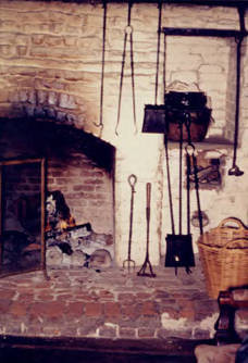 Fireplace with utensils in Avila Adobe