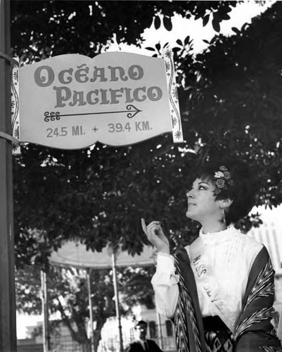 Hilda Udalgo pointing to a sign at the Sunset Boulevard closing