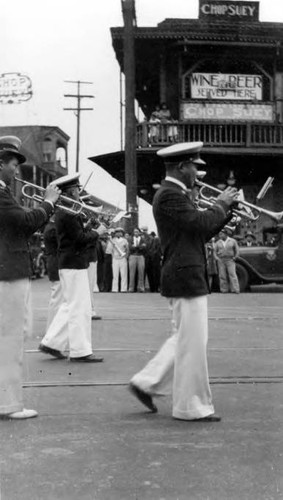 A band directed by Peter Soo Hoo Sr. performing in Old Chinatown on Alameda Street, which is now the site of Union Station