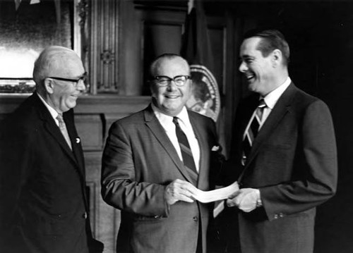 Two men receiving a check from Reinecke