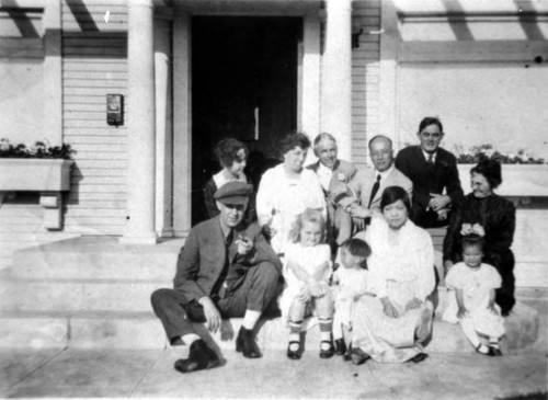 Group in front of house on Clinton Street: Lung Yep, Soy Wan Tong Lung, boy is Joe, girl is Dorothy