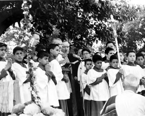 Priests and altar boys on stand