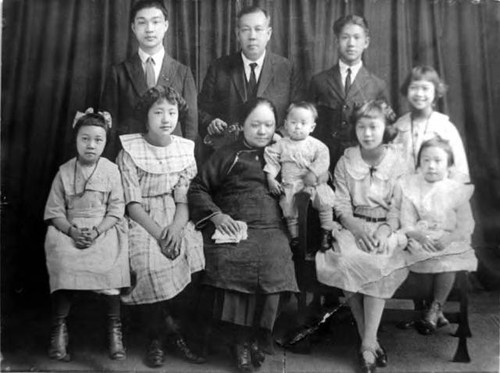 Rose Wong in family portrait--Rose Wong is frist from right, standing. Back Row: Lee Ying Middle Row (left to right): Harry, Mr. Lee, Charles, and Bertha Front Row: Helen, Lily, Mrs. Lee (Aileen), Tommy, Rose, and Florence