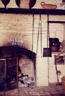 Fireplace with utensils in Avila Adobe