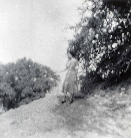 Woman standing on a hillside landscape (Spencer Chan Family)