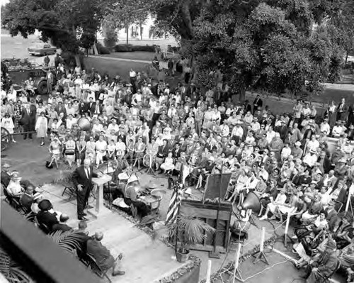 Crowd in front of a platform for the Firehouse Dedication