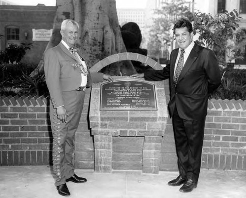 Mario Valadez and friend by plaque