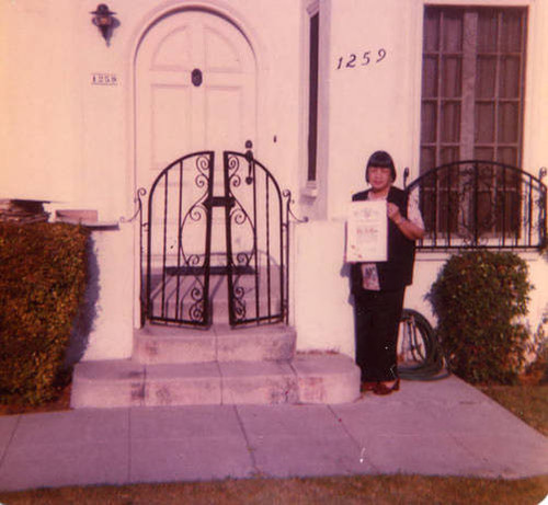 Lily Chan holding an award in front of her home in Los Angeles