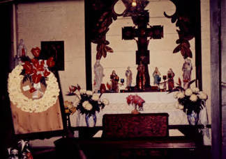 Altar and wreath of white flowers in Avila Adobe