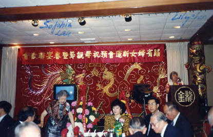 New Life Club's Mother's Day celebration at the Golden Dragon. Lily Lum Chan is at the podium and Sophia Lew, the current president, is standing