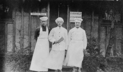 Three cooks standing in front of an officer's mess hall