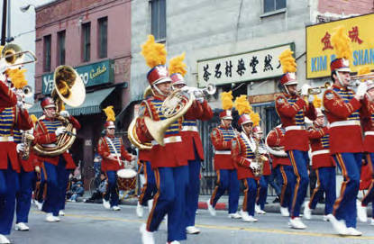 Chinese New Year parade in New Chinatown celebrating the Year of the Ram on February 16, 1991. The marching band is passing Yee Mee Loo Restaurant on Spring Street