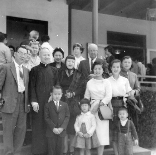 Catholic Center, Lily Lum Chan and others standing with clergy